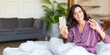 © Stavros - Middle aged woman lies in bed with cell phone. She wake up make selfie for social media posts. Modern technology and digital addiction concept. Format photo 2x1.