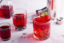 Red Cocktail With Raspberries On A Pink Background
