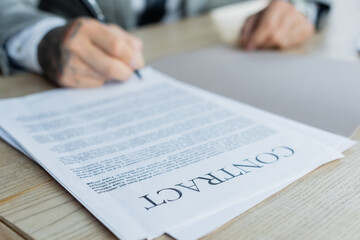 Sticker - cropped view of blurred businessman signing contract in office