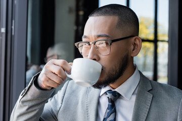 Sticker - asian businessman in formal wear and eyeglasses drinking coffee in office