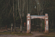 An Old Cemetery Gate With Brick Pillars Giving A Moody Or Scary Feeling. Balozu Kapi, Jelgava, Latvia