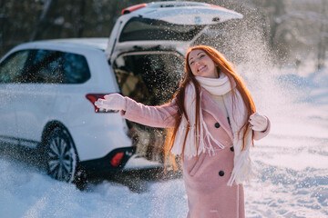 Winter holidays. Happy young caucasian woman is enjoying outdoor recreation on sunny winter day.