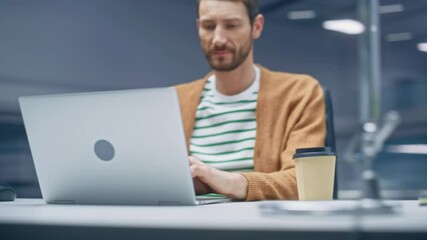 Poster - 360 Degree Modern Office: Caucasian Businessman Sitting at His Desk Working on a Laptop Computer. Man working with Big Data e-Commerce Statistics Analysis. Tracking Shot. Camera Moving Around