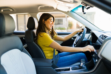 Woman turning up the volume on the car radio