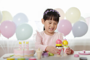 Wall Mural - young girl pretend playing food preparing at home