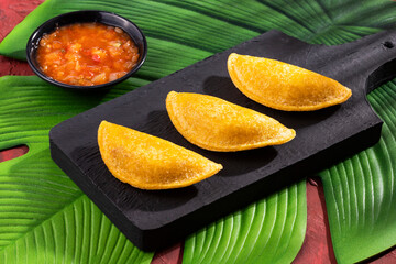 Wall Mural - Delicious and traditional Colombian empanadas with spicy sauce