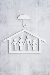 Wall Mural - Wooden family figure under umbrella. Health and live insurance concept