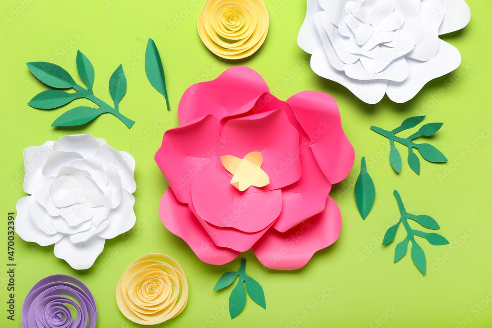 Beautiful handmade paper flowers on color background