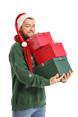 Wall Mural - Handsome young man with Christmas gifts on white background