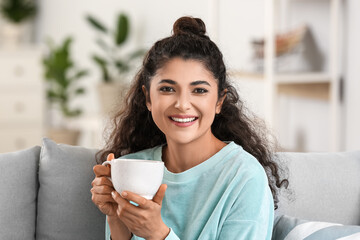 Beautiful woman drinking tea at home