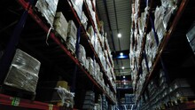 Packages Stacked High On Shelving System Of Industrial Warehouse; Storage Facility