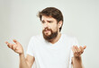 © SHOTPRIME STUDIO - Man in a white t-shirt hand gestures anger light background