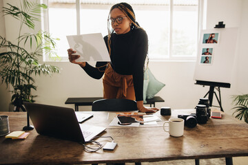 Freelance photographer looking at a photograph in her office