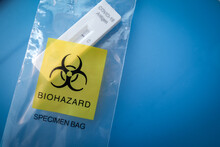 Used Covid 19 Antigen Test Kit Showed Negative Test Puting In Biohazad Speciment Bag On Blue Background An Infection Test Kit For Self-detection .