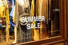 Shop Window Of The Clothing Store With Big White Words Summer Sale In The Shopping Mall.