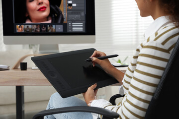 Fototapete - Professional retoucher working with graphic tablet at desk in office, closeup