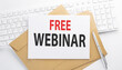 © Iryna - Text FREE WEBINAR on the envelope on the keyboard