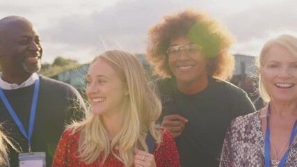 Wall Mural - Camera tracks along faces of group of university or college students and tutors outdoors on campus smiling and looking at camera - shot in slow motion