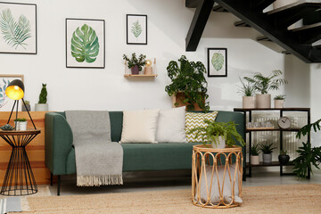 Sticker - Stylish living room interior with comfortable sofa and green plants