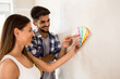 © didesign - Happy young couple choosing color for new house