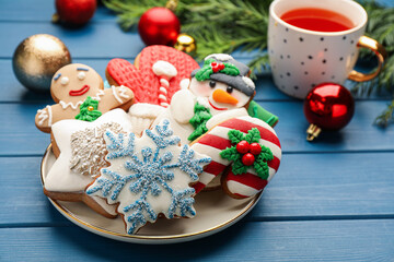 Wall Mural - Delicious homemade Christmas cookies and festive decor on blue wooden table