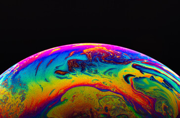 Wall Mural - Virtual reality space with abstract multicolor psychedelic planet. Closeup Soap bubble like an alien planet on black background.