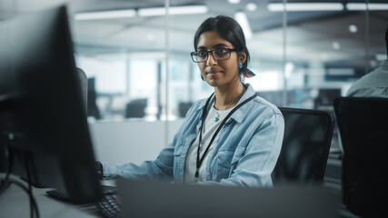 Wall Mural - Diverse Office: Portrait of Talented Indian Girl IT Programmer Working on Desktop Computer in Friendly Multi-Ethnic Environment. Female Software Engineer Wearing Glasses Develop Inspirational App
