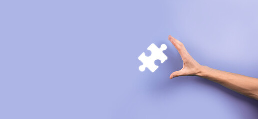 Wall Mural - Businessman hands connecting puzzle pieces representing the merging of two companies or joint venture, partnership, Mergers and acquisition concept.