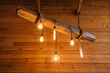 Vintage incandescent light bulbs to create a lamp atmosphere in the interior of a wooden house