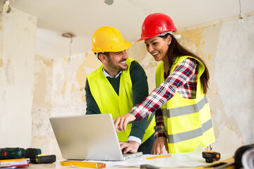 Wall Mural - Architects using laptop at construction site