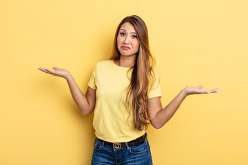 Wall Mural - asian pretty woman shrugging with a dumb, crazy, confused, puzzled expression, feeling annoyed and clueless