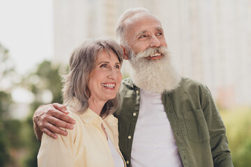 Photo of happy dreamy grey haired positive old couple look enjoy weekend summer good mood outside outdoors in park