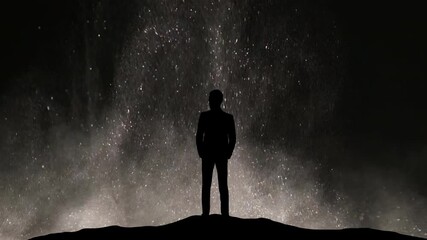 Wall Mural - the man standing on a night snowstorm background. slow motion