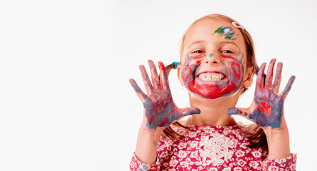 Portrait of happy smiling beautiful young girl with colorful painted face against white background. Copy space. Horizontal image.