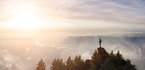 Adventurous Caucasian Adult Woman Standing on top of a Rocky Mountain. Sunset Sky Art. 3d Rendering peak. Aerial Background Image from British Columbia, Canada. Adventure Concept