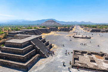 Wall Mural - Teotihuacan archaeology site with Sun pyramid and Alley of the Dead seen from moon pyramid, Mexico. Focus on Sun Pyramid in background.