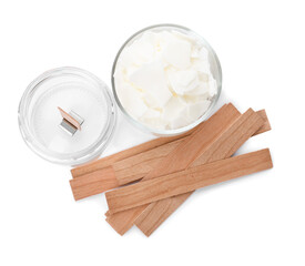 Wax flakes and wooden wicks on white background, top view. Making homemade candle