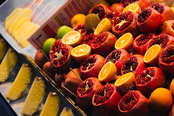 Pomegranate, oranges and pineapples on fruit stand in Istanbul, Turkey