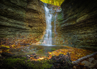 a small waterfall in rautal close to jena in thuringia at autumn