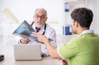 © Elnur - Young male patient visiting old male doctor radiologist