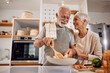 © kerkezz - An older couple cooking a healthy vegan meal with vegetables together