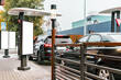 Customers waiting in their cars line up at the drive thru facility of a fast food restaurant. Empty blank vertical banners installed near drive-thru window. Mockup. Mock-up. Poster