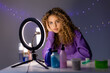 © КРИСТИНА Игумнова - beauty blogger girl leads a live broadcast, communicates with subscribers, answers questions, doing a review of cosmetics and care products. young woman vlogger. ring lamp. space for text
