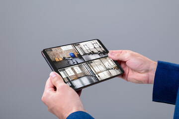 Poster - Hands of caucasian man holding tablet with view of gym from security cameras on screen