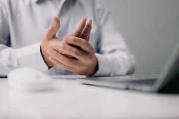 Poster - Close-up of a man with wrist ache from using a computer. Occupational pain causes hand discomfort in the office syndrome.