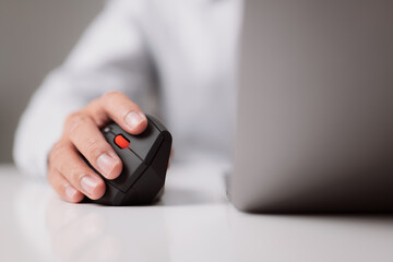 Poster - The man who works from his house. A close-up of a hand with a computer mouse that is both comfortable and ergonomic. Working on the notion of COVID-19.