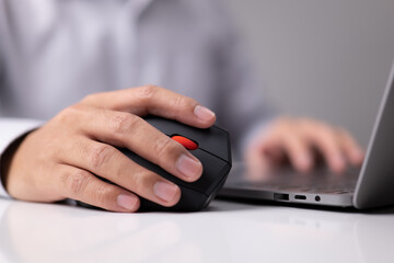 Poster - Man hand uses a vertical ergonomic computer mouse joystick.