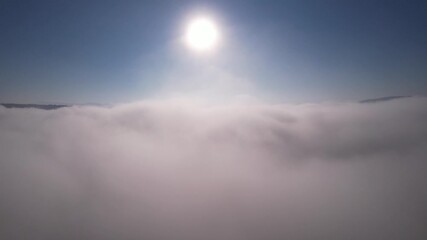 Wall Mural - moving forward to sun is rising above the morning mists fog of clouds over the tree-covered mountain