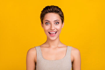 Wall Mural - Photo of cute excited amazed positive lady open mouth omg reaction wear grey top isolated yellow color background