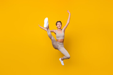 Sticker - Full length body size view of pretty cheerful girl jumping working out shaping weight loss isolated over bright yellow color background